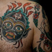 Indian demon face coloured tattoo