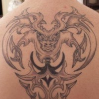 Gargoyle with tribal tracery tattoo