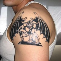 Minimalistic gargoyle black ink tattoo on shoulder