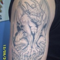 Realistic gargoyle beast tattoo on arm