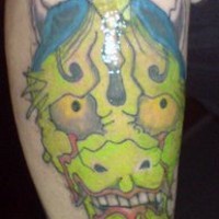 Green gargoyle deamon head tattoo
