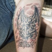 Gargoyle on chimney with name tattoo