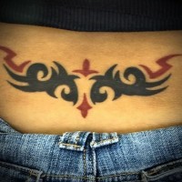 Black and red tribal tracery on lower back