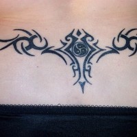 Black tribal tracery tattoo on lower back