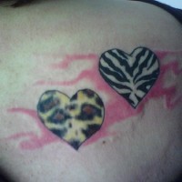 Zebra and leopard textured hearts tattoo