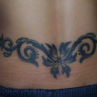 Flower tracery tattoo on lower back