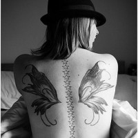Girly butterfly wings and stars tattoo on back