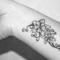 Girly flowers wrist tattoo