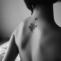 Elegant small rose tattoo on back