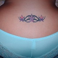 Stars and tracery tattoo on tail base