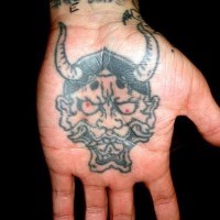 Crazy, horned, awful devil hand tattoo