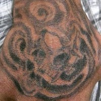 Awful stormy monster spot hand tattoo