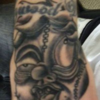 Disgusting black fat talking monster hand tattoo