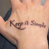 Keep it simple, simple inscription hand tattoo