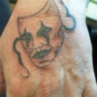 Tatuaggio sulla mano la maschera triste