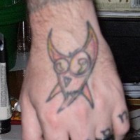 Name near fingers & horned puss hand tattoo