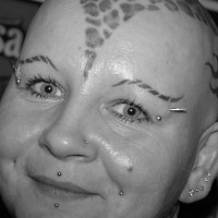 La testa di donna con tatuaggio come leopardo