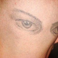 Head tattoo, very realistic colourless eyes