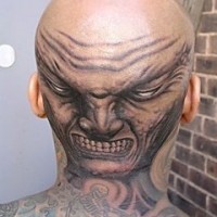 Dreadful, laughing, wrinkled, teethy monster head tattoo
