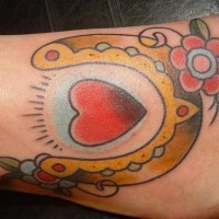 Heart with horseshoe and flower tattoo