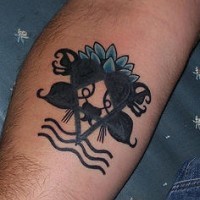 Black heart symbol with lotus tattoo