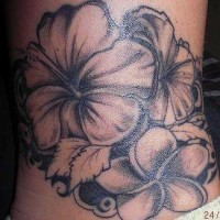 Black ink hibiscus tattoo on lower back