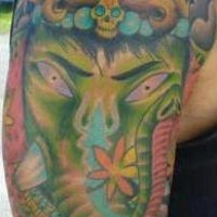 Green angry ganesha shoulder tattoo