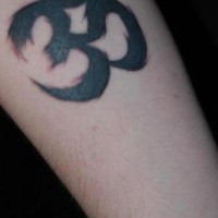 Black ink om symbol tattoo