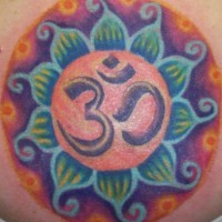 Om symbol in colourful lotus tattoo