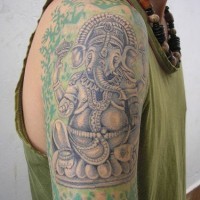 Blue ganesha in rest with hindu pattern tattoo