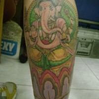 Ganesha in gold leg tattoo