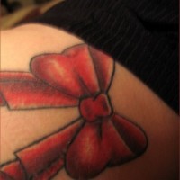 Picturesque, red, beautiful styled  bow hip tattoo