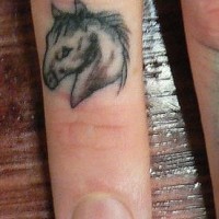 Small horse head tattoo on finger