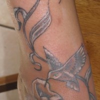 White hummingbird and vine tattoo