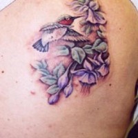 Nice hummingbird in violets tattoo