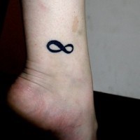 Black ink Infinity tattoo on leg