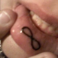 Infinity symbol tattoo on inner lip