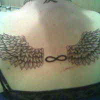 Infinity symbol and wings tattoo on back