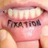 Inside lip tattoo, fixation , black bright word