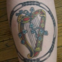 Detailed irish harp tattoo