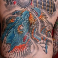 Blue asian dragon tattoo on lower back