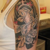 Black koi tattoo on shoulder