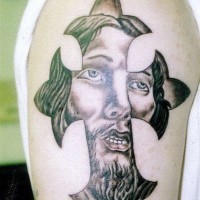Jesus face in cross tattoo
