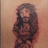 Jesus black ink tattoo on shoulder