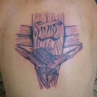 Jesus on wooden cross tattoo on back