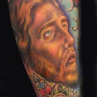 Jesus themed sleeve tattoo in colour