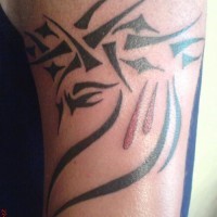 Tribal tracery black ink tattoo