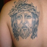 Jesus face tattoo on back