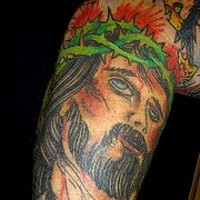 Colourful Jesus in crown of thornes tattoo