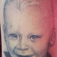 Realistic kid face tattoo